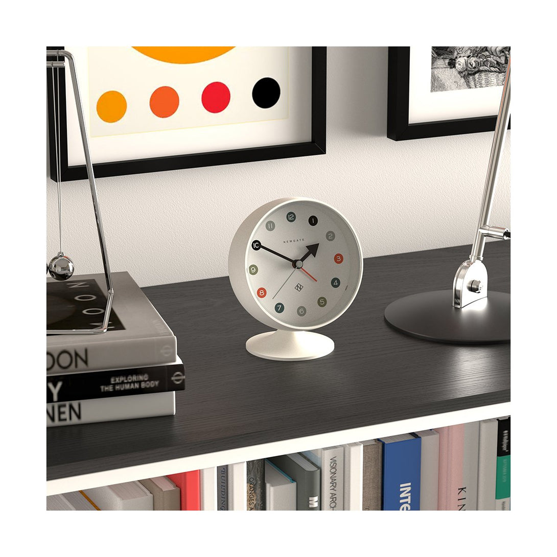 Skew style shot view of the Retro Spheric alarm clock by Newgate World with an Arabic dial and a Pebble White case