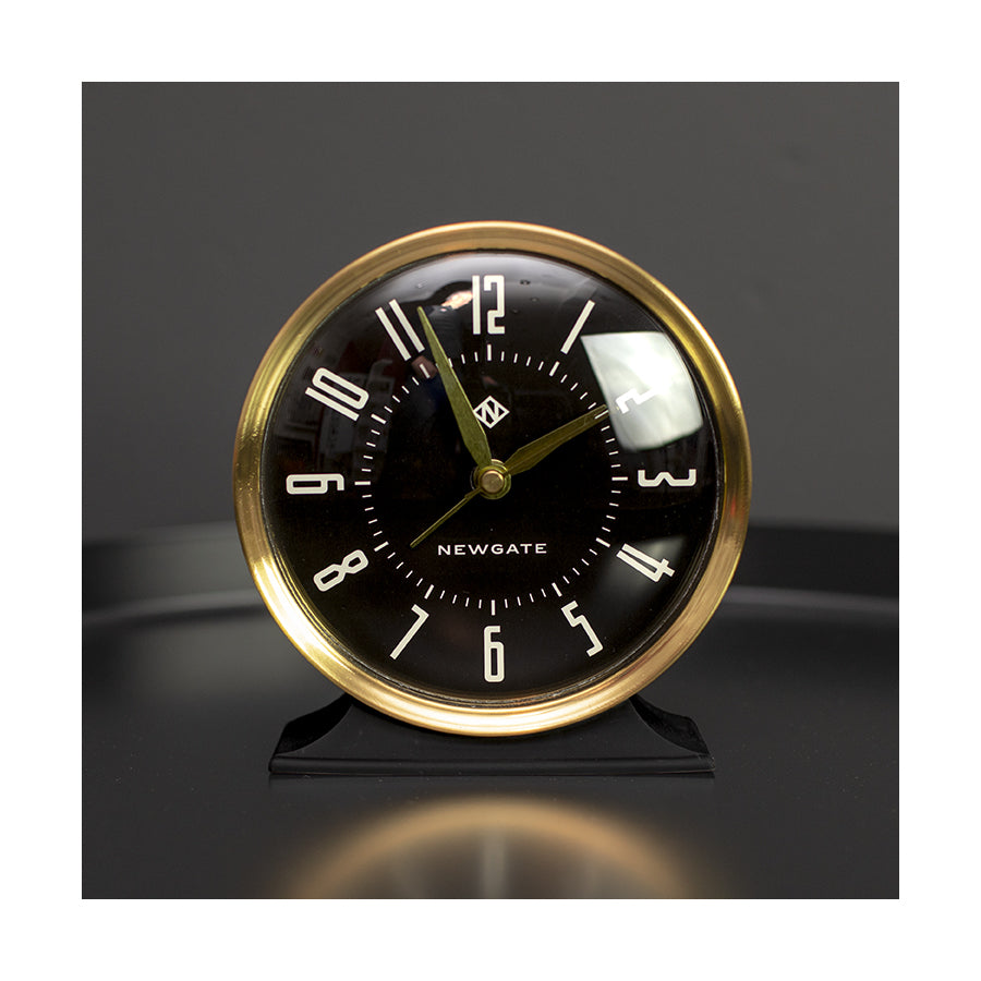 Art Deco Black and Gold Hotel alarm clock by Newgate World on a table - HOTE527CK