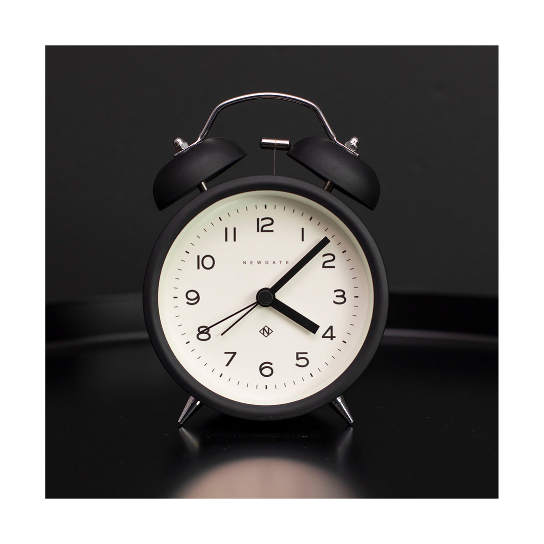Black Charlie Bell Echo alarm clock by Newgate World on a table