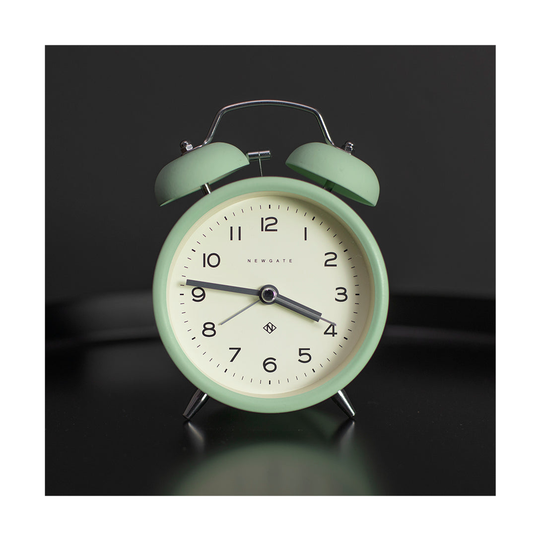 Neo Mint Charlie Echo alarm clock by Newgate World on a table