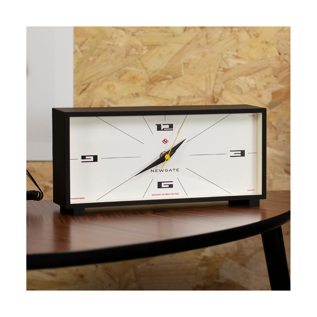Close up of the Newgate Clocks rectangular Thunderbird mantel clock with a cream dial and black case 